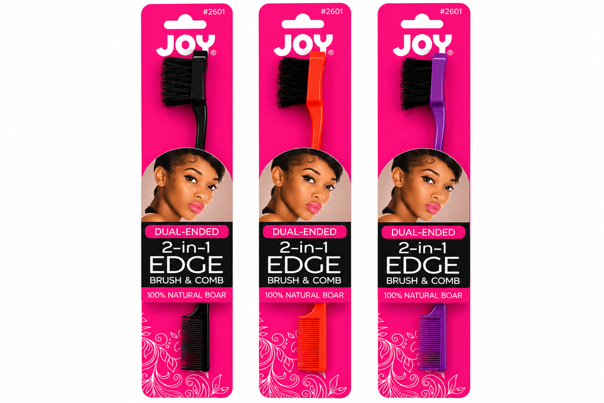 Three JOY dual-ended 2-in-1 brush and comb tools shown in pink retail packaging, each with a different handle color: black, orange, and purple.