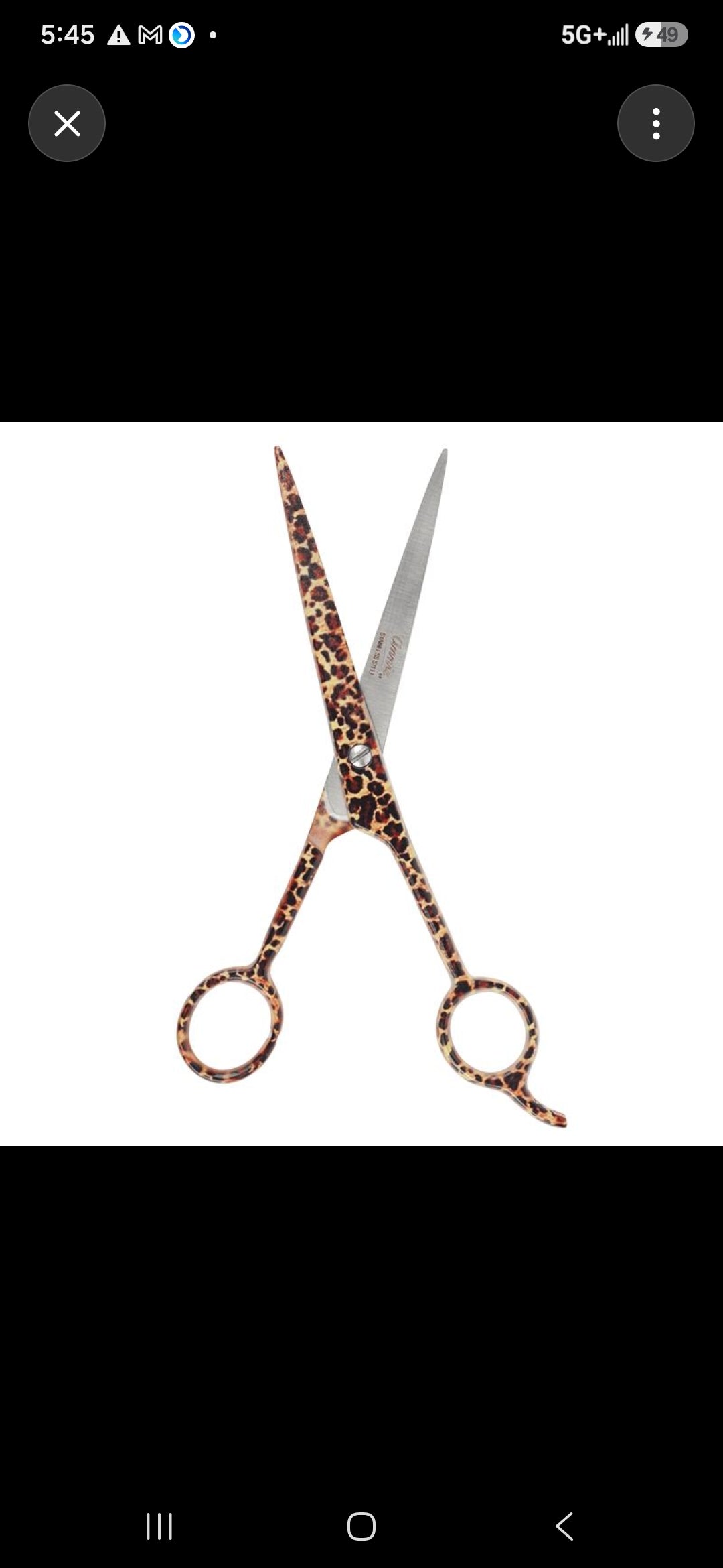 A pair of fashion shears with leopard-print handles and silver-toned blades, shown on a plain white background.