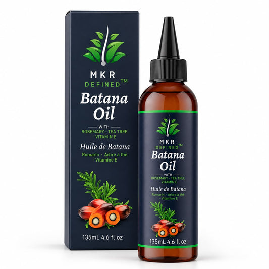 A bottle of MKR Defined Batana Oil next to its dark navy blue packaging box, featuring green leaf graphics and illustrations of red batana fruits, on a white background.